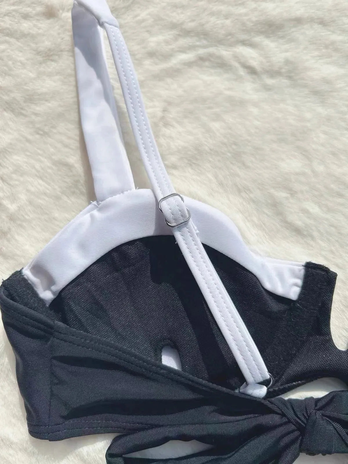 Black women's low waist bikini swimsuit with split sides and stitching detail