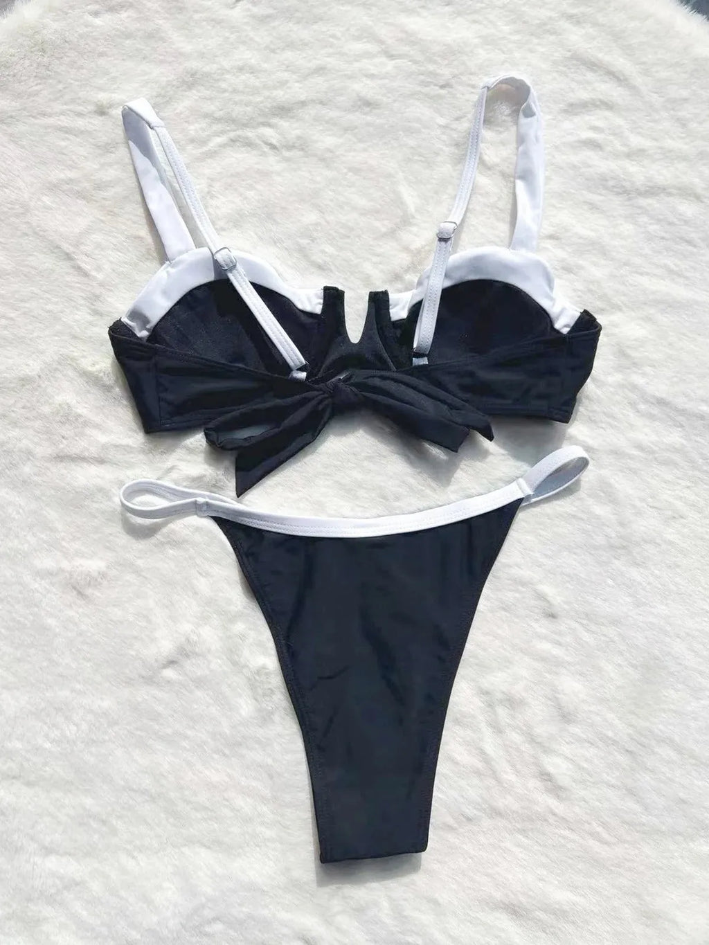 Black women's low waist bikini swimsuit with split sides and stitching detail