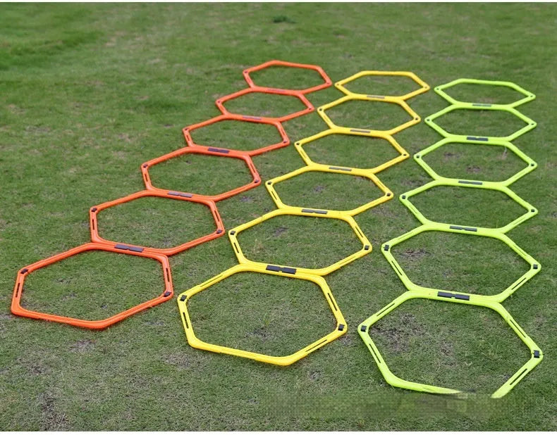 Set of six foldable yellow, green, and orange hexagon plastic agility training rings for football drills.