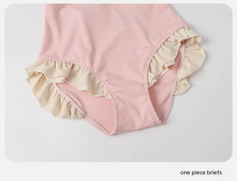 Pink women's conservative one-piece swimsuit with a Siamese cute design on a mannequin