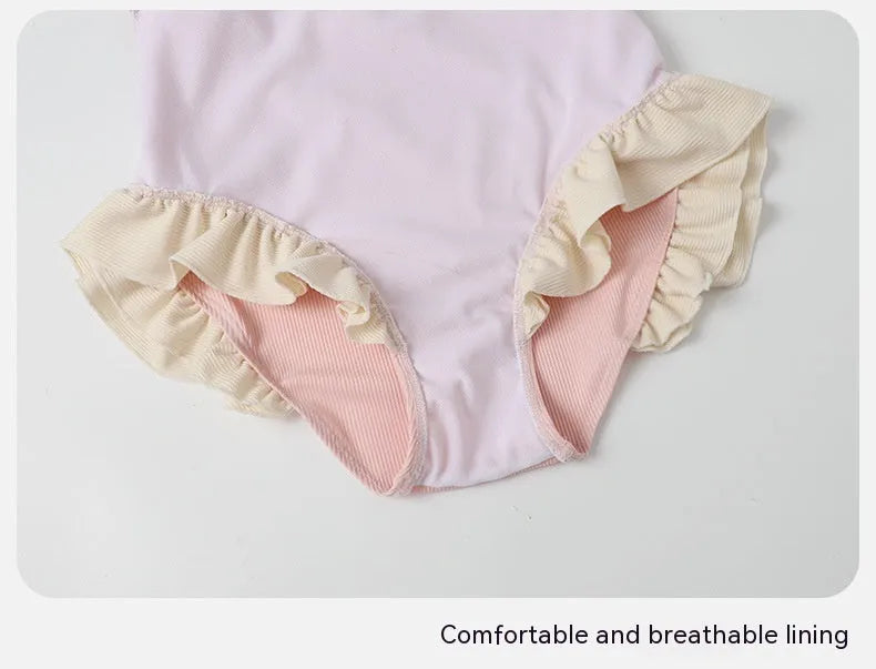 Pink women's conservative one-piece swimsuit with a Siamese cute design on a mannequin