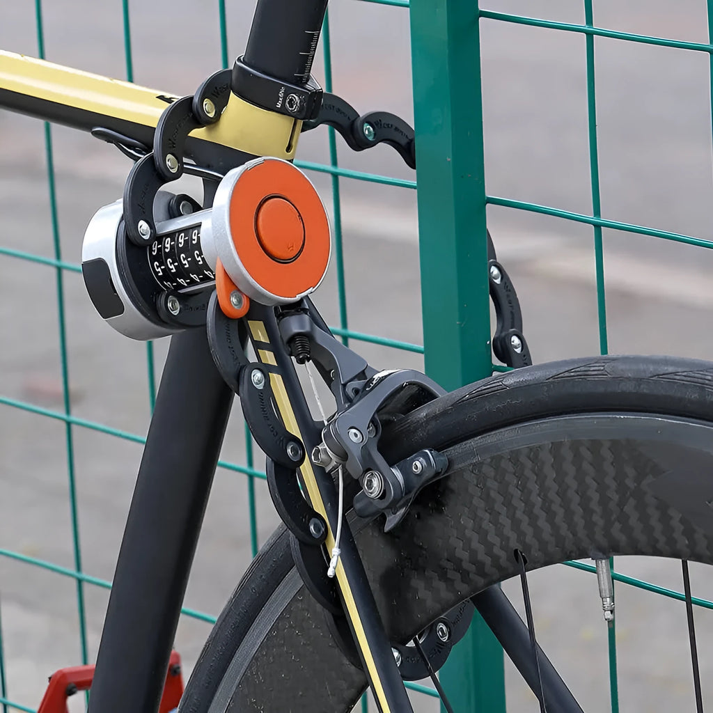 Black and black orange portable bicycle folding lock with a segmented, link-based design on a bicycle frame.