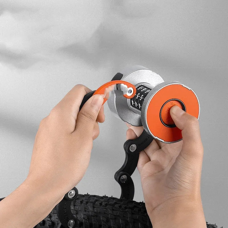 Black and black orange portable bicycle folding lock with a segmented, link-based design on a bicycle frame.