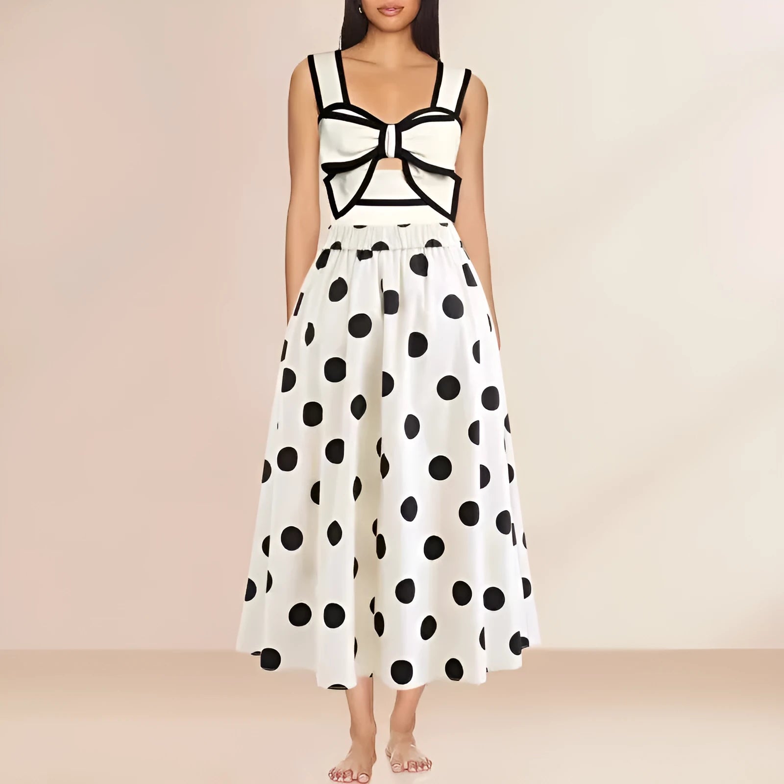 Women's black one-piece swimsuit with a white bow and round skirt on a mannequin, front view.