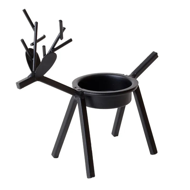 Black iron elk Christmas candlestick holder on table with candle