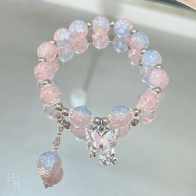 A Chinese style glass bracelet with bamboo leaf and bead designs on a wrist.