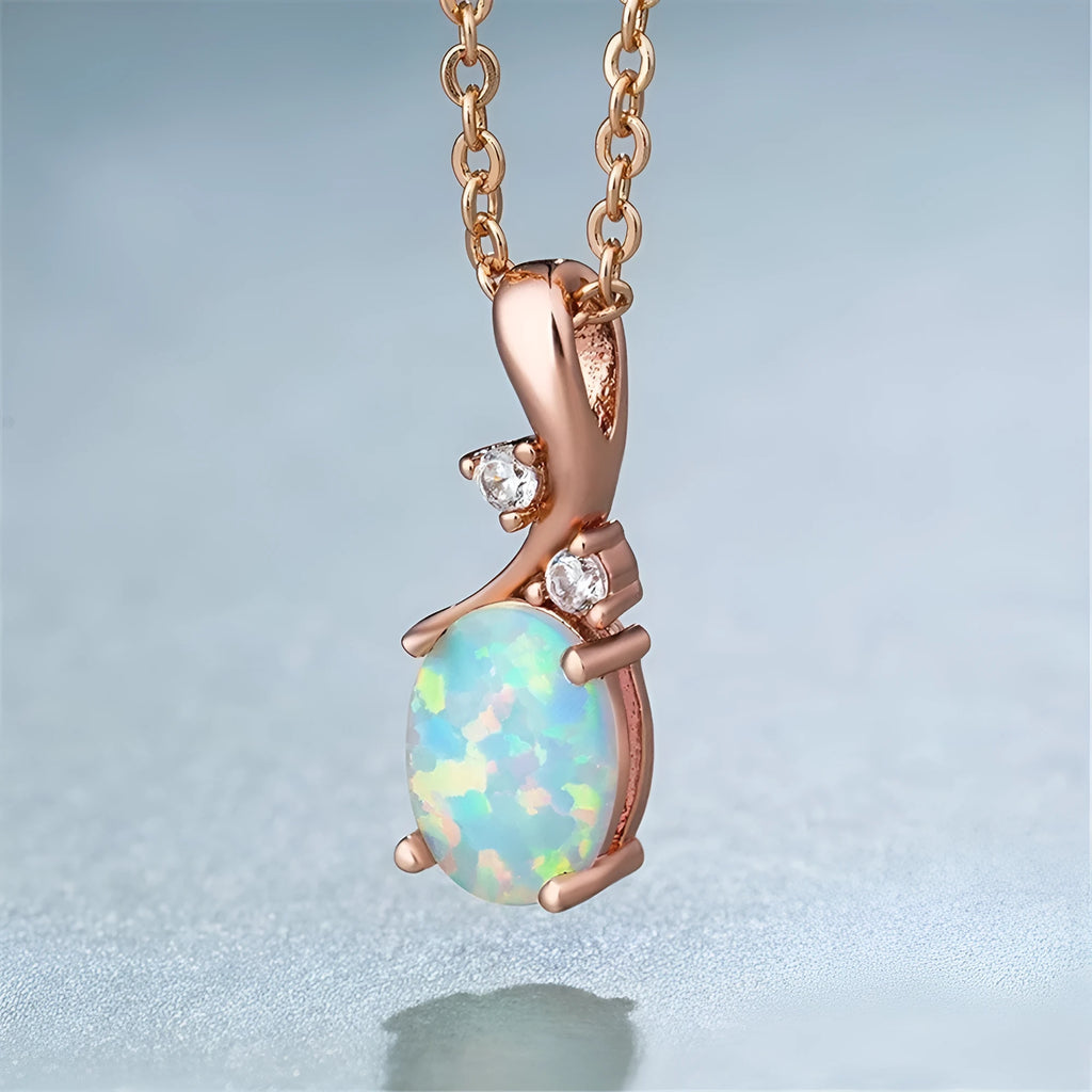 Water drop shaped opal pendant on an adjustable silver tone necklace chain