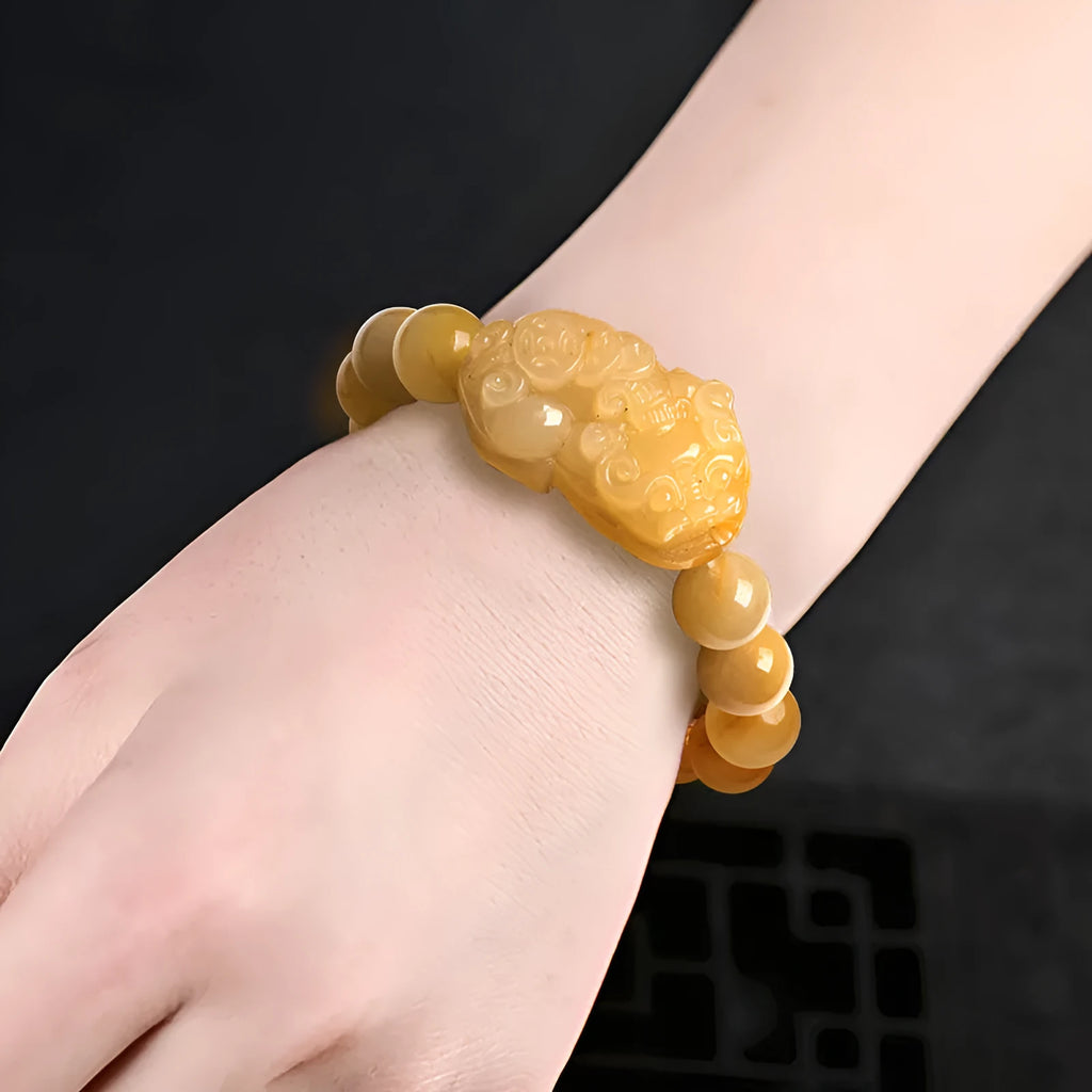 Golden thread Jinsi Jade money bracelet with carved coin charms on beaded strand