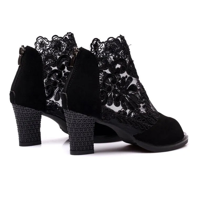 Black gladiator sandals with lace upper, square high heel, and zip closure on ankle