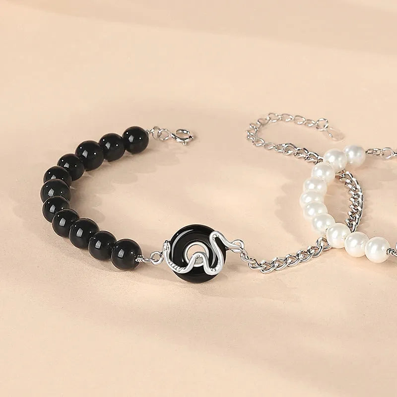 925 sterling silver couple bracelet with snake charm, obsidian pearl, and safe buckle in new Chinese style.