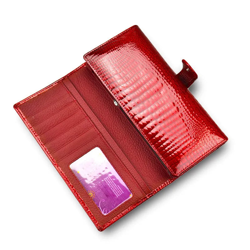 Women's leather coin purse with crocodile pattern embossing in red colour showing interior pigskin lining