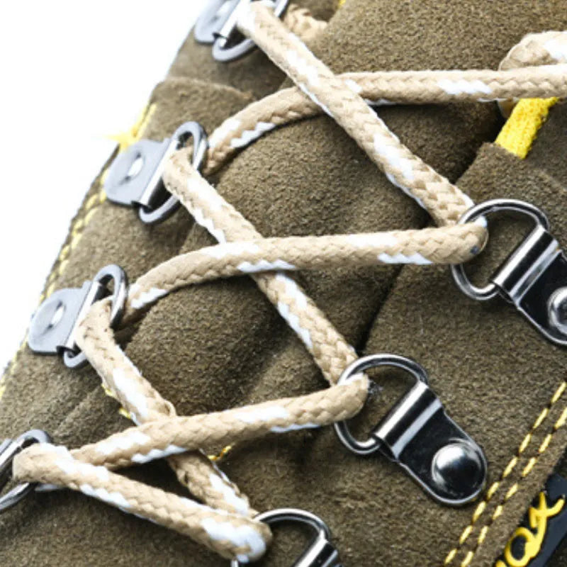 Bronze coloured low-cut cow suede safety work boots with a steel toe cap on a grey background