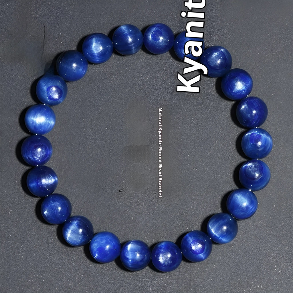 Polished blue crystal ball bracelet with Ruyi charm on a white background.