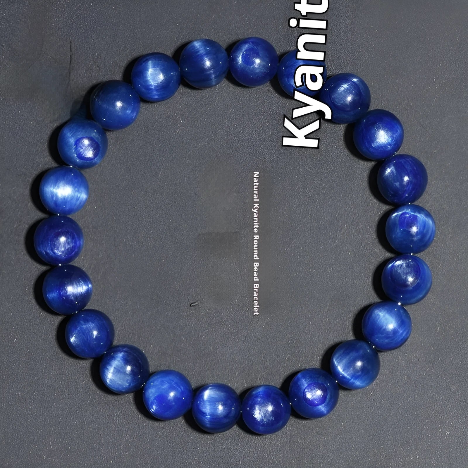 Polished blue crystal ball bracelet with Ruyi charm on a white background.