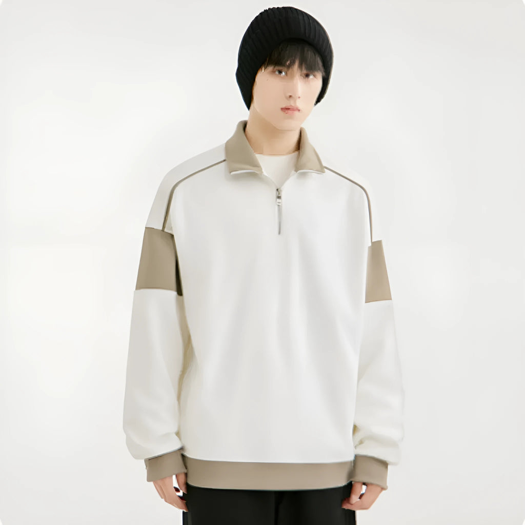 Man wearing a thin beige corduroy hooded sweater with drop shoulders and loose lapels.