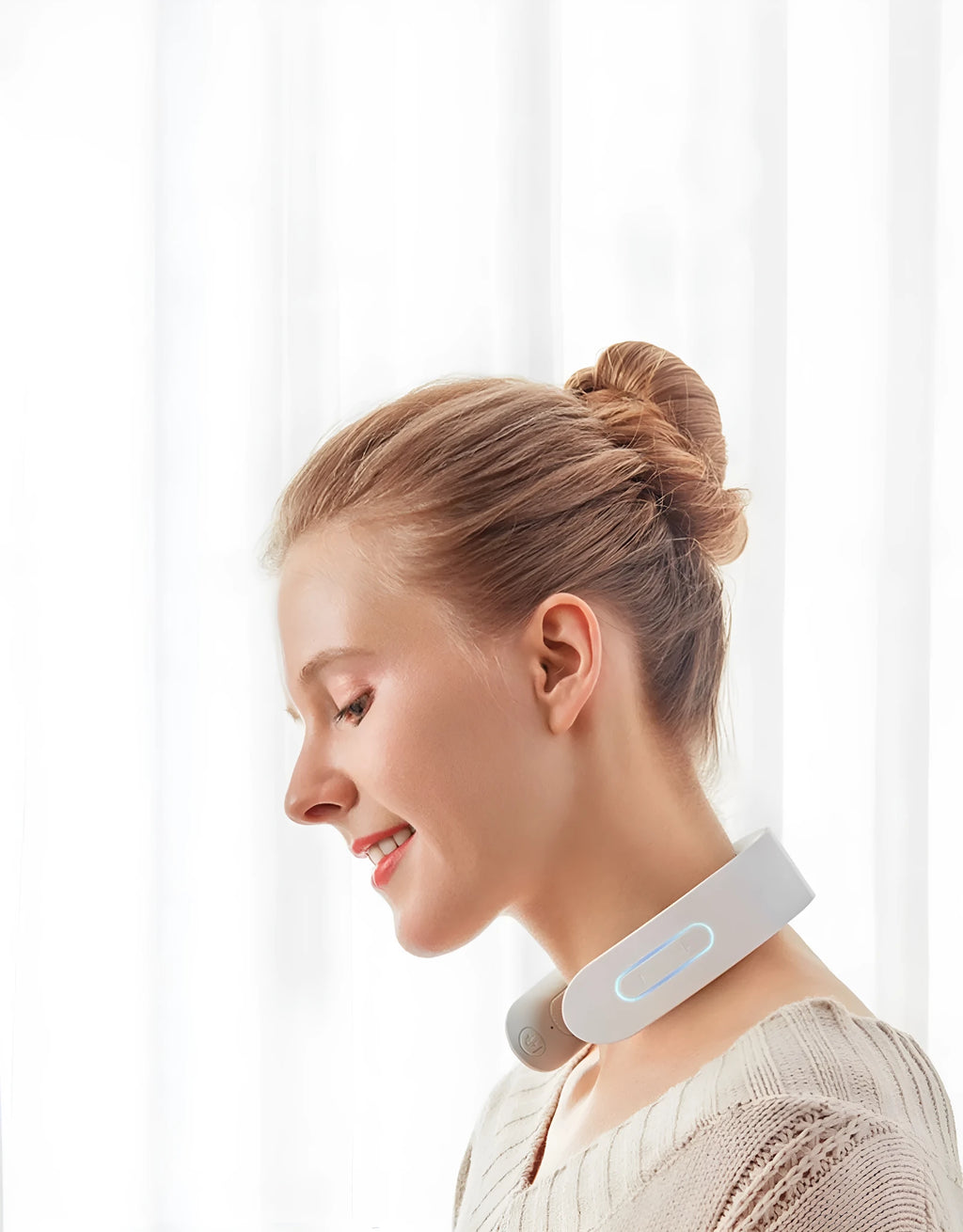 White electric acupressure massager for back neck and shoulder pain relief on a grey background.