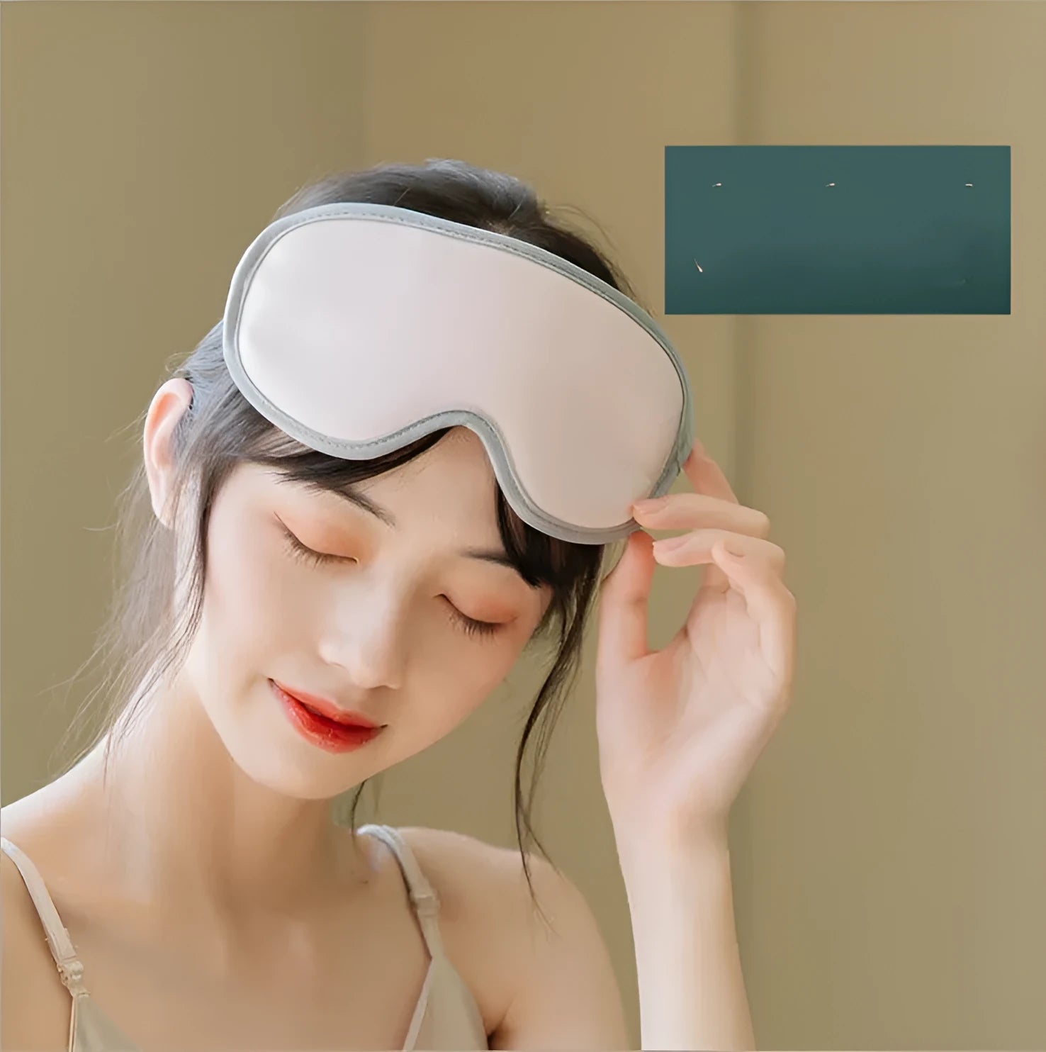 Green portable eye spa massage goggles with USB cable on a table.