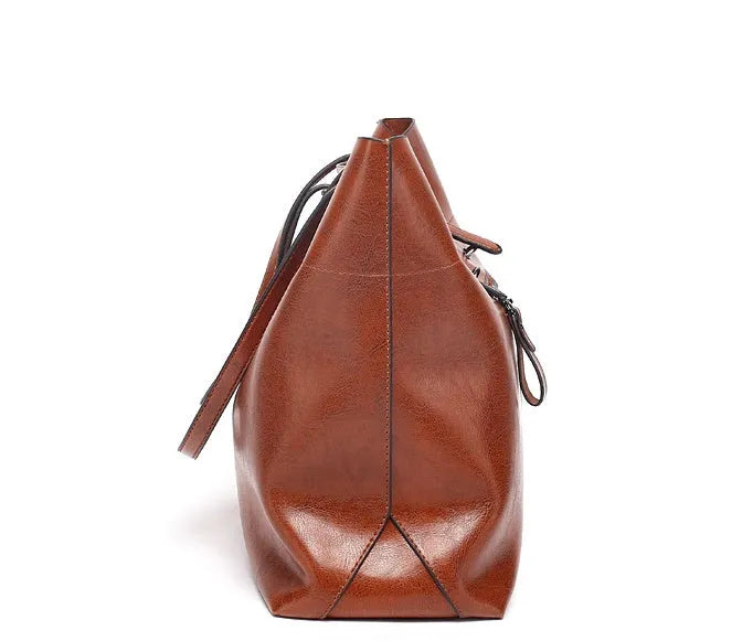 Genuine cowhide leather cross-body handbag showing two compartments and available in five colours