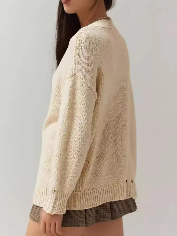 Women's loose-fitting jacquard knit acrylic sweater in milky white beige colour with round neck