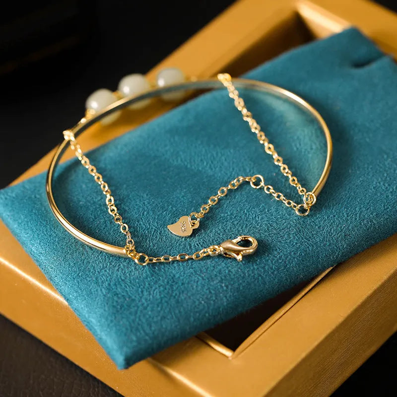 Women's jade lucky beads bracelet with gold inlay, showing single, double, and three bead version options.