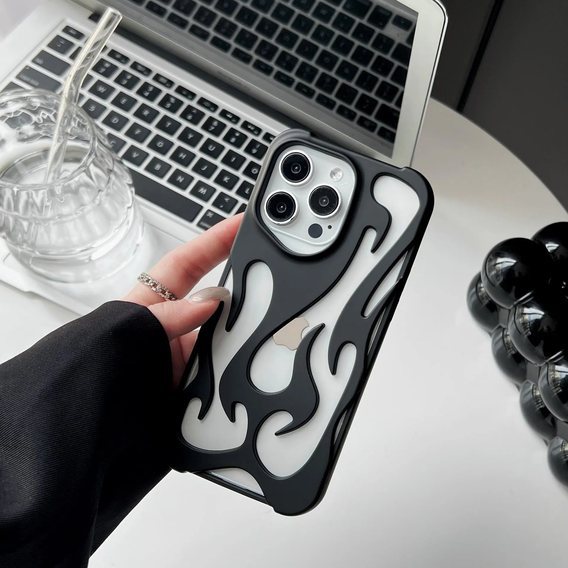 Electroplated iPhone case with hollow flame pattern design in gold, black, purple, and silver finishes