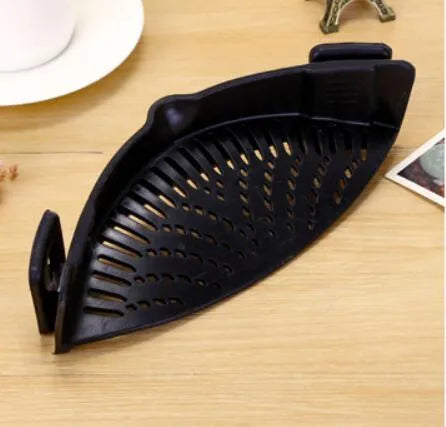 Silicone clip-on funnel colander in kitchen draining liquid from pot