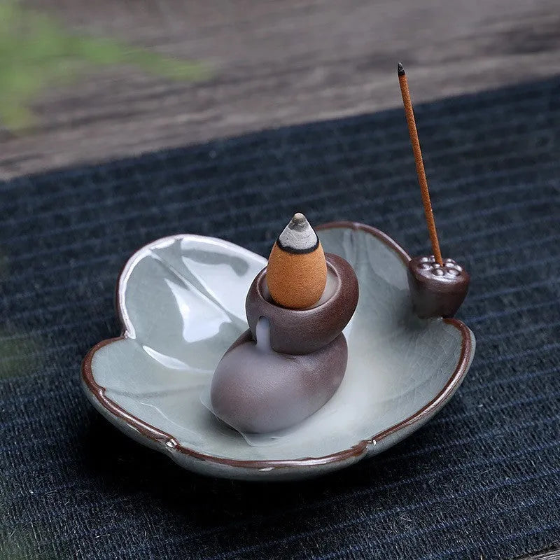 Purple clay ceramic reverse flow incense burner with lotus and plum blossom motifs
