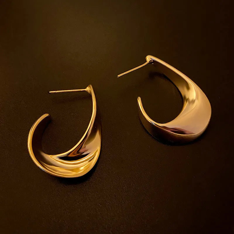 Pair of twisted geometric design metal earrings in gold or silver electroplated finish