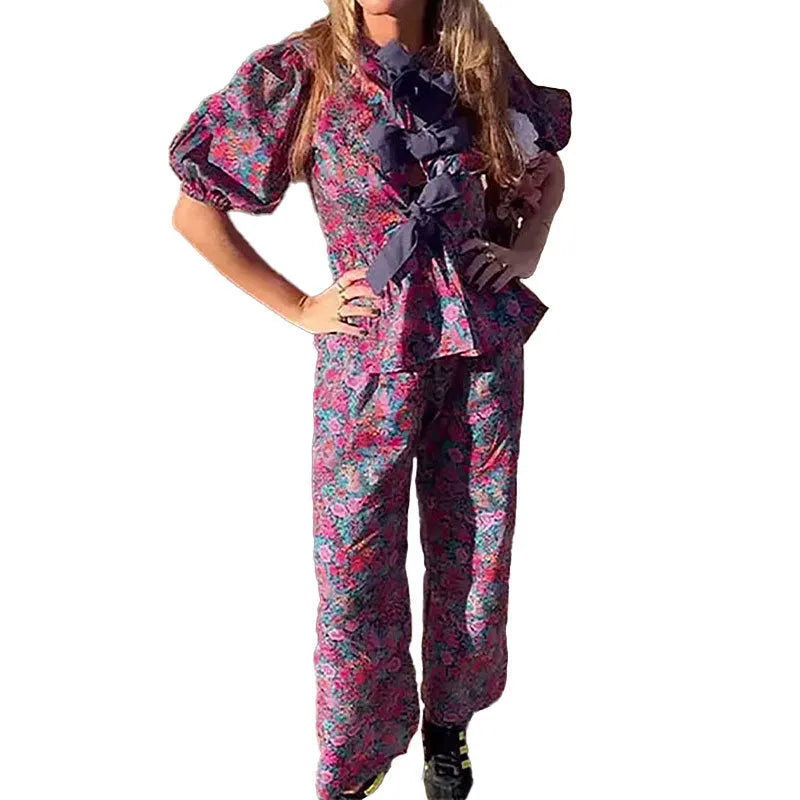 Floral printed two-piece trouser suit with puff sleeves and tie-neck detail in picture colour
