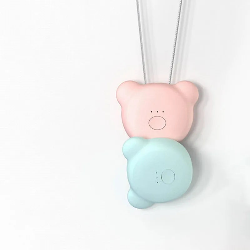Pink and blue wearable USB air purifier necklace shown on a person, with dimensions 1.5 by 5.7 by 4.5 cm.