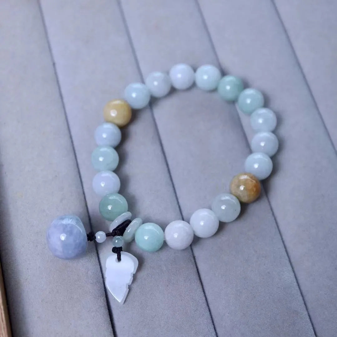 Natural green jade bracelet with a hanging Maitreya Buddha charm on a geometric band.