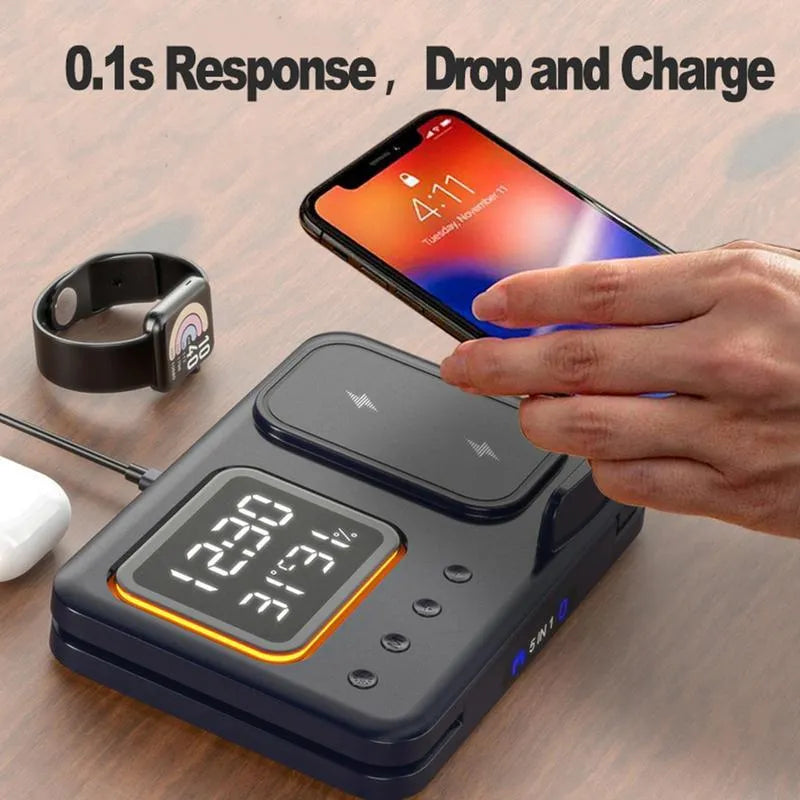 Black foldable wireless charging station displaying time and temperature, charging a phone and smartwatch.