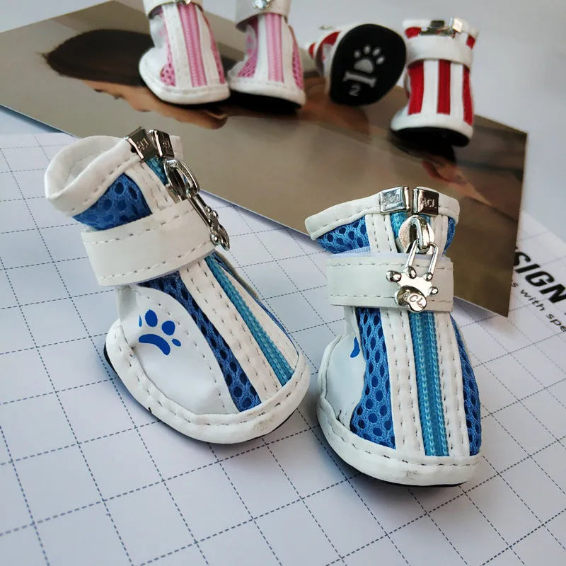 Set of four blue cloth dog shoes for small dogs with non-slip soles and a zip fastening.
