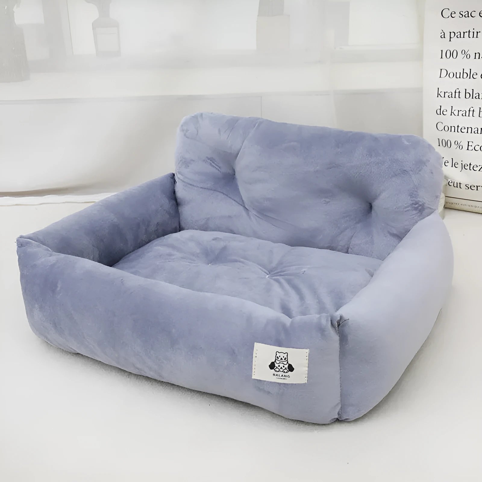Car-mounted pet outing nest in stain-resistant cloth showing grey and blue plaid colour options