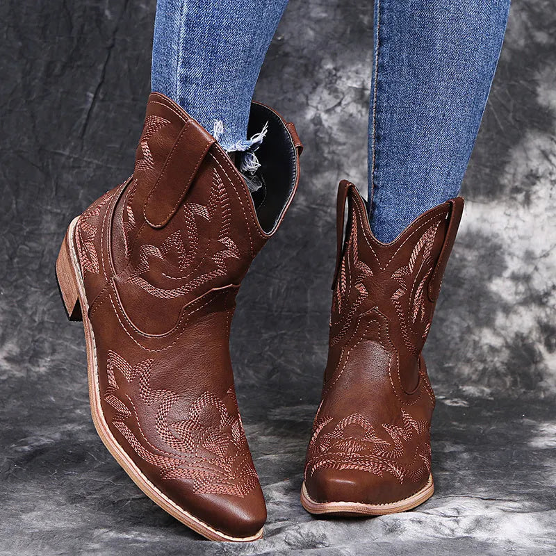 Women's blue embroidered cowboy boots with low chunky heel and pointed toe.