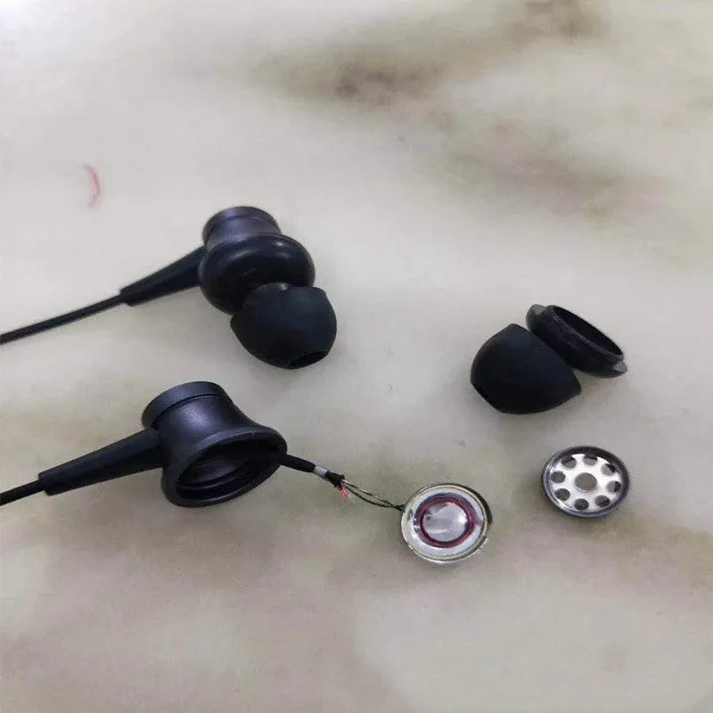 Piston-style wired in-ear headphones with a 3.5mm plug, shown in black, blue and red colour options.