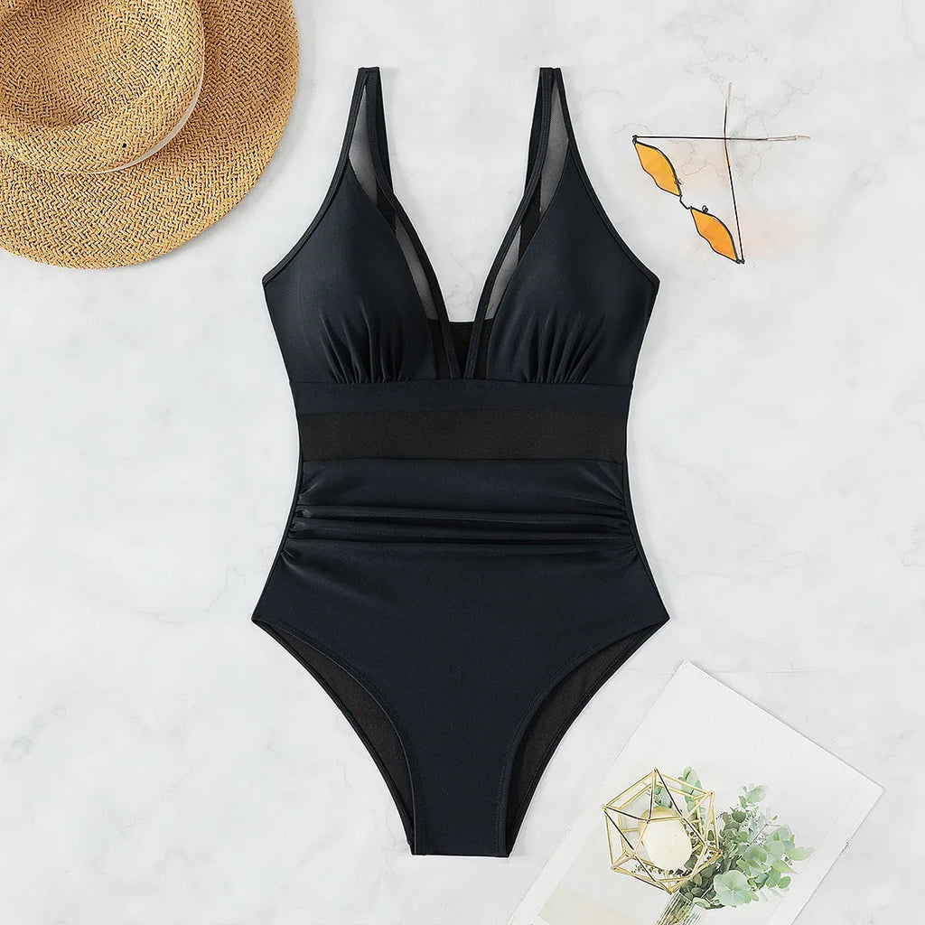 Black women's halter neck one-piece swimsuit with mesh detailing and briefs style cut
