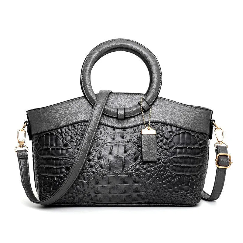 Brown fabric women's handbag showing front zipper compartment and internal organiser pockets.