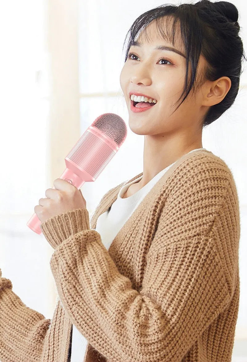 Wireless Bluetooth karaoke microphone in pink, blue, and green colour options showing integrated audio design.
