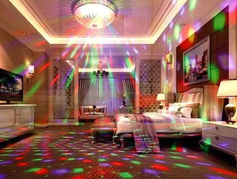 Black and white LED laser magic fan stage light with remote control on a stand.