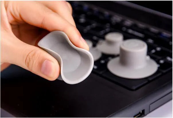 Grey plastic laptop cooling pad set showing two larger and two smaller pads for temperature reduction