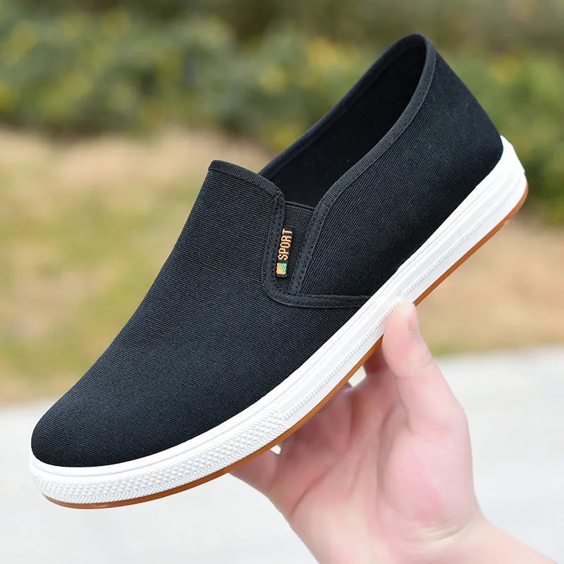 Men's black canvas slip-on shoes with round toe and shallow mouth design