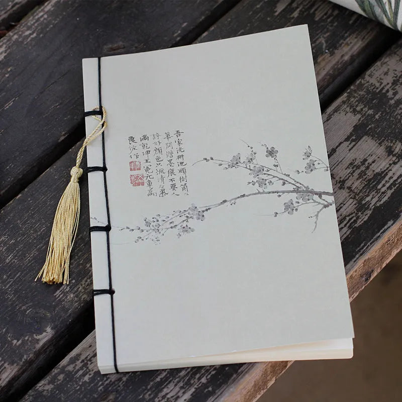 A5 antique wire-bound notebook with retro painting cover, thread binding, and black tassels.