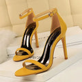 Women's ankle-strap high heel sandals with open toe in black artificial PU leather.
