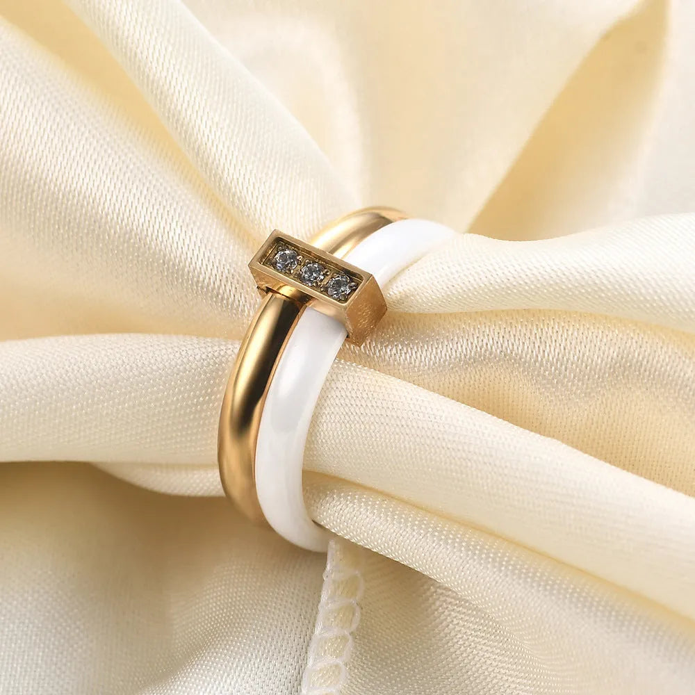 Ceramic ring with glossy stitching and inlaid zirconium in steel black or gold white colour, 6mm geometric shape