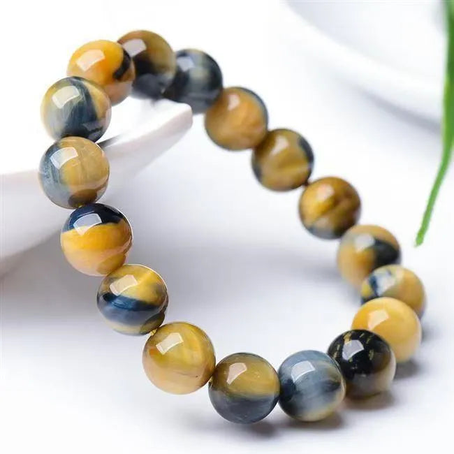 Handmade fantasy tigereye agate bracelet with round beads in a single circle, shown in natural stone colours.