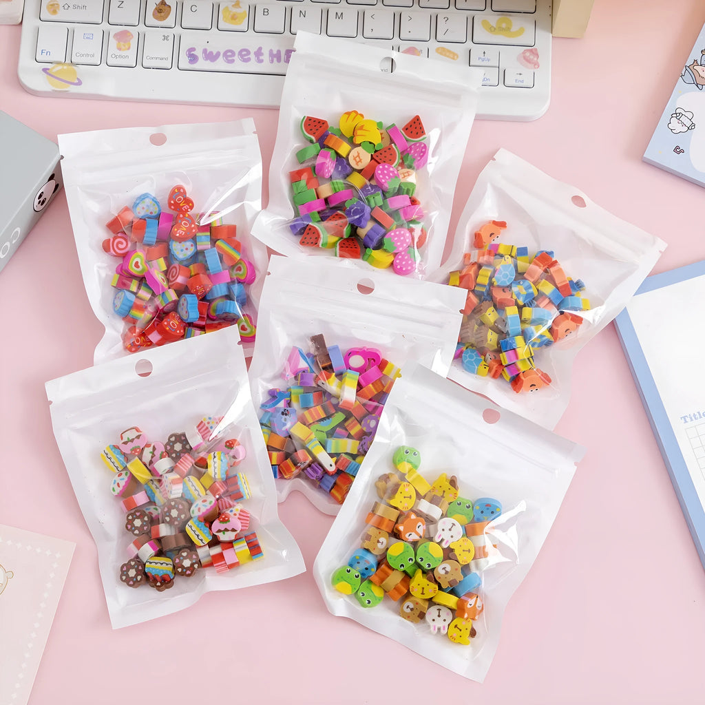 Assortment of 50 colourful miniature cartoon erasers including fruit, animal and theme designs.