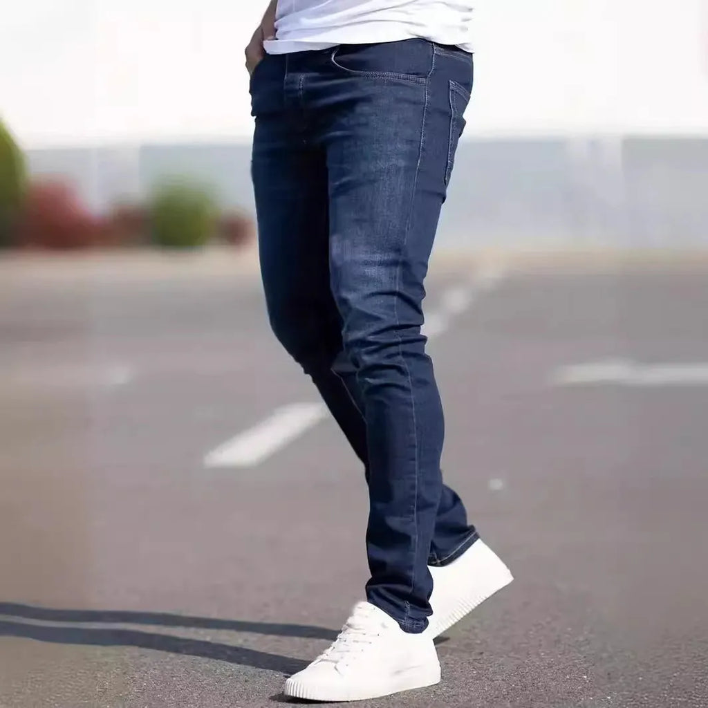 Dark blue men's slim-fit casual jeans with a worn finish and skinny leg opening.