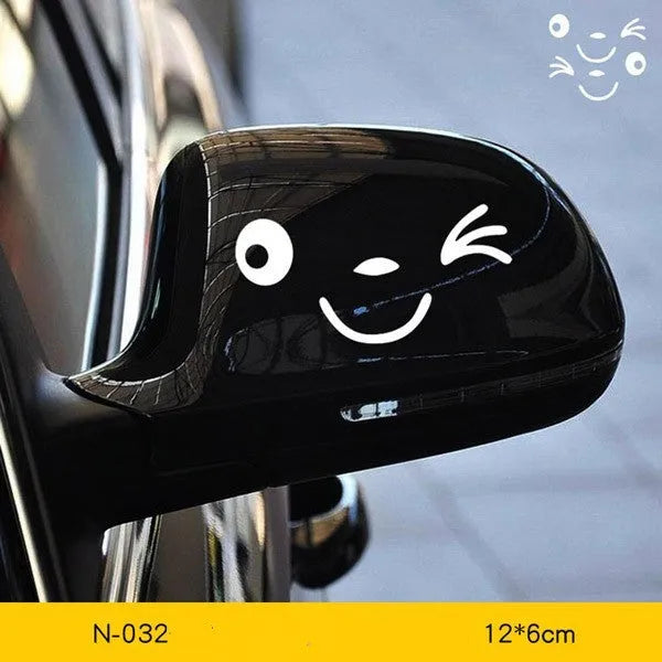 A pair of reflective cartoon car eye stickers on a vehicle body.