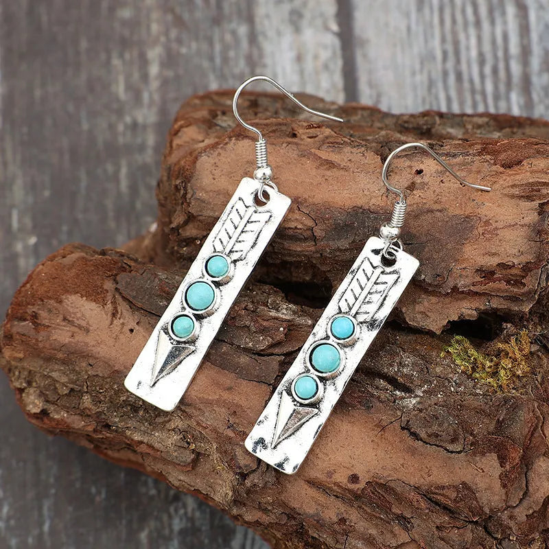 Silver-coloured geometric earrings with turquoise inlay measuring 20-24cm long